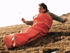 Picture of someone sliding down a hill in a plastic bag.