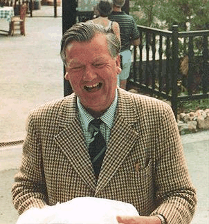 Picture of Trevor Greensmith with a birthday present outside an apartment block in Cyprus.